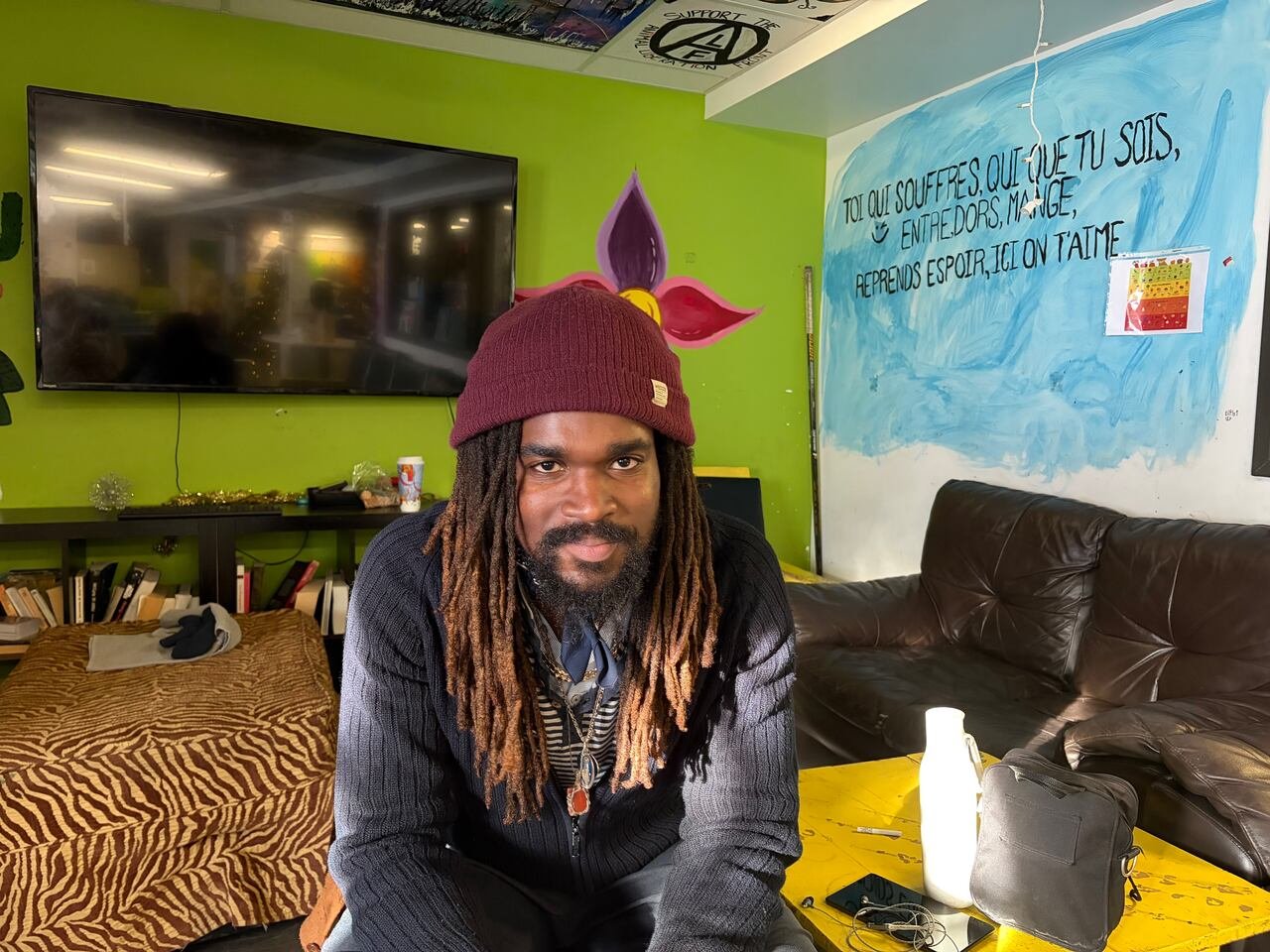 A man smiles, looking at the camera