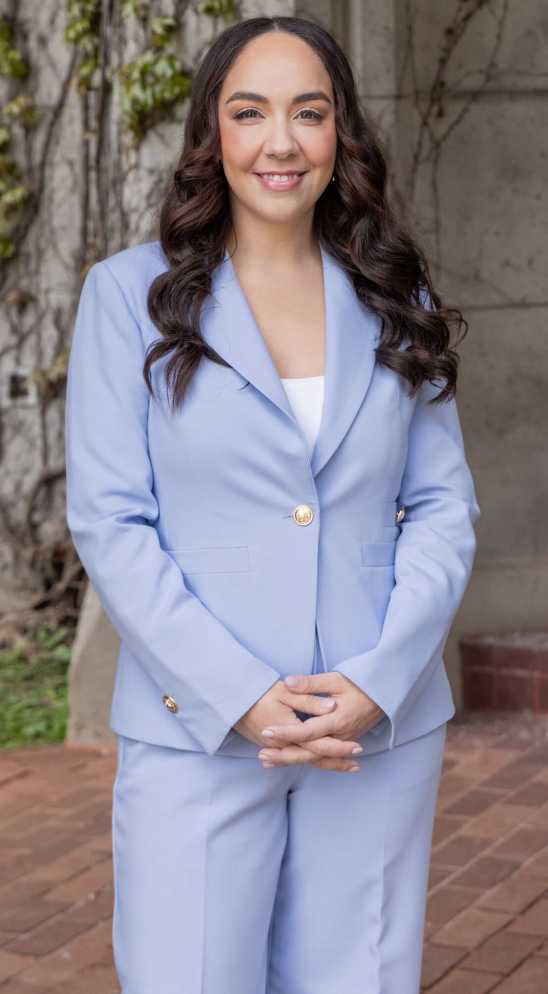default-356 Woman in blue suit standing with folded hands