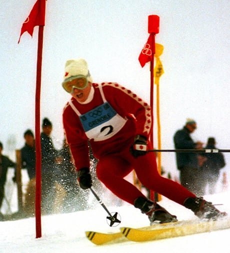 A woman skis down a hill.